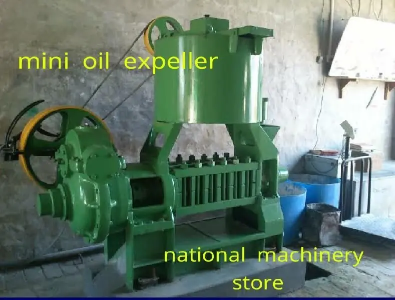 Green mini oil expeller with motor and pulley drive at National Machinery Stores, Kadi