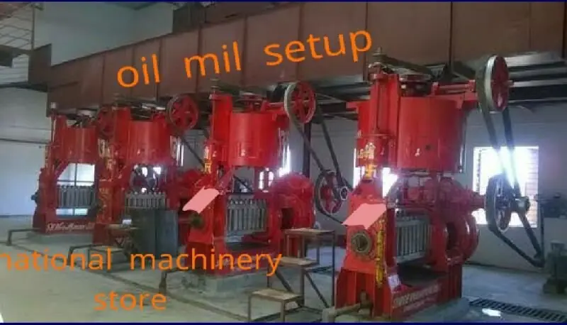 Oil mill setup with a row of red oil expellers installed by National Machinery Stores