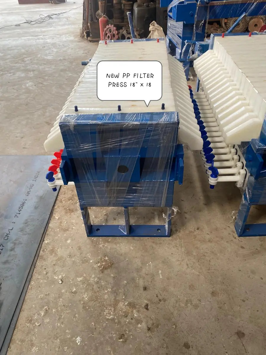 Hydraulic plastic oil filter press with white PP plates on a blue frame